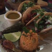 Tacos Jalisco · Steak and Mexican sausage, Chihuahua cheese, onions, and cilantro. Served with rice, charro ...