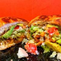Torta · A Mexican bun with choice of meat, refried beans, lettuce, tomato, avocado and sour cream.