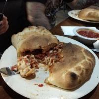 Calzone · A pocket pizza, stuffed with ricotta and mozzarella cheese and 2 toppings.