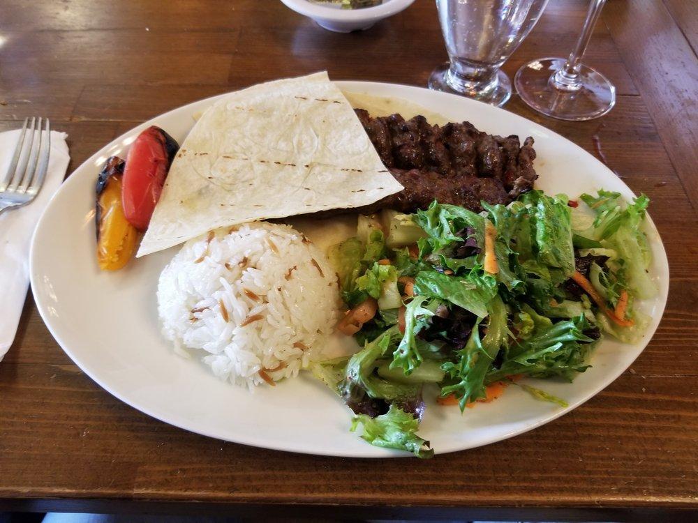 Adana Kebab · Hand chopped lamb mixed with red bell peppers, seasoning and grilled on skewer. Served with house salad and your choice of rice or bulgur.