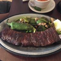 Carne Asada · A tender juicy skirt steak char-boiled to perfection. Served with scrumptious grilled veggie...