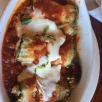Eggplant Rollatine · Eggplant tightly fried and stuffed with ricotta, topped with marina sauce and mozzarella.
