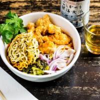 Oki Curry Ramen · Curry broth and coconut milk garnished with shallot, pickled cabbage, fried chicken and cris...