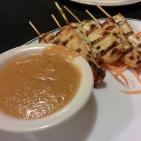 Chicken Satay · Marinated in a blend of Thai herbs and coconut milk. Skewered and grilled. Served with peanu...