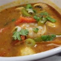Tom Yum · Thai hot and spicy soup with mushrooms, tomatoes, red and green bell peppers, onions, baby c...