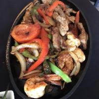 Fajitas · Sauteed with bell pepper medley, tomatoes and onions. Served with guacamole, rice, beans, an...