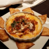 Queso Fundido · Blend of 3 cheeses, Monterey Jack, queso fresco, and cheddar, topped with pork chorizo, sour...