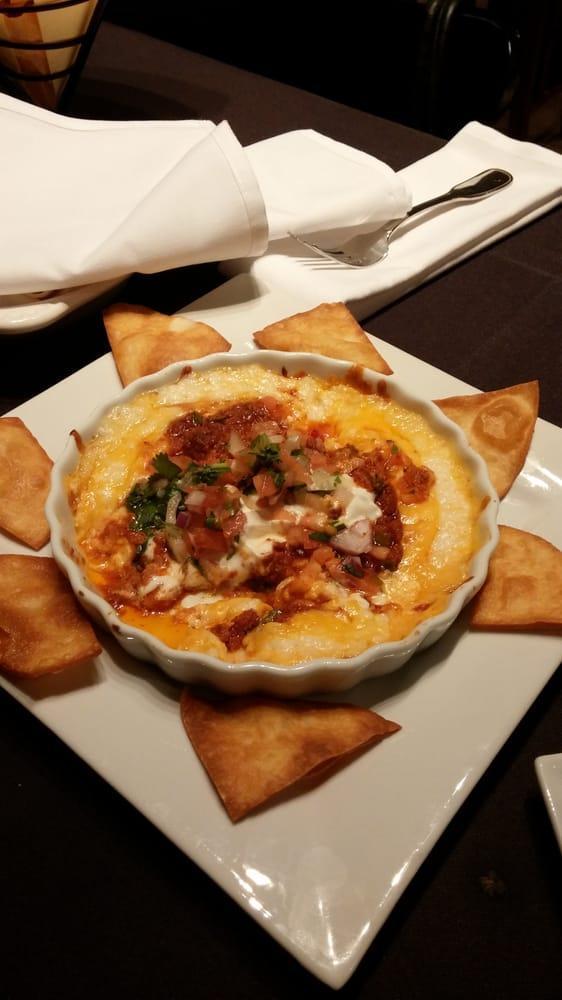 Queso Fundido · Blend of 3 cheeses, Monterey Jack, queso fresco, and cheddar, topped with pork chorizo, sour cream and pico de gallo served with warm flour tortilla points.