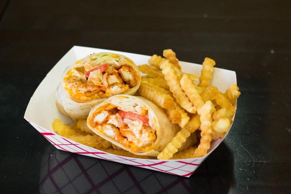 Spicy Buffalo Chicken Wrap · Ranch, shredded cheddar cheese, lettuce and tomato with a spicy homemade Buffalo sauce. Free range - all natural. Spicy.