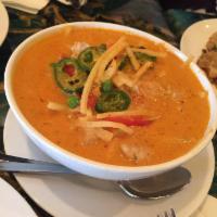 Red Curry · Light coconut red curry with peas, bamboo shoot, pepper and basil leaves. Served with jasmin...