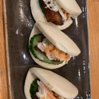 Pork Buns · 3 per order. Slice of savory pork belly dressed with Bonchon soy garlic sauce, topped with c...