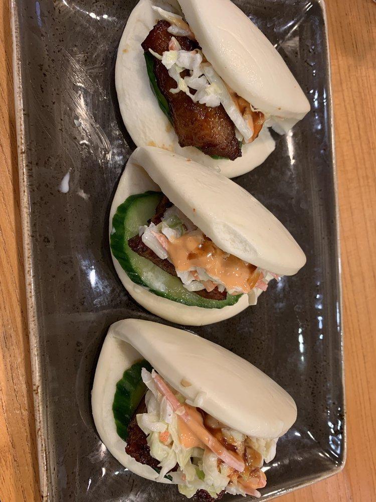 Pork Buns · 3 per order. Slice of savory pork belly dressed with Bonchon soy garlic sauce, topped with cucumbers, coleslaw, spicy mayo, and katsu sauce.