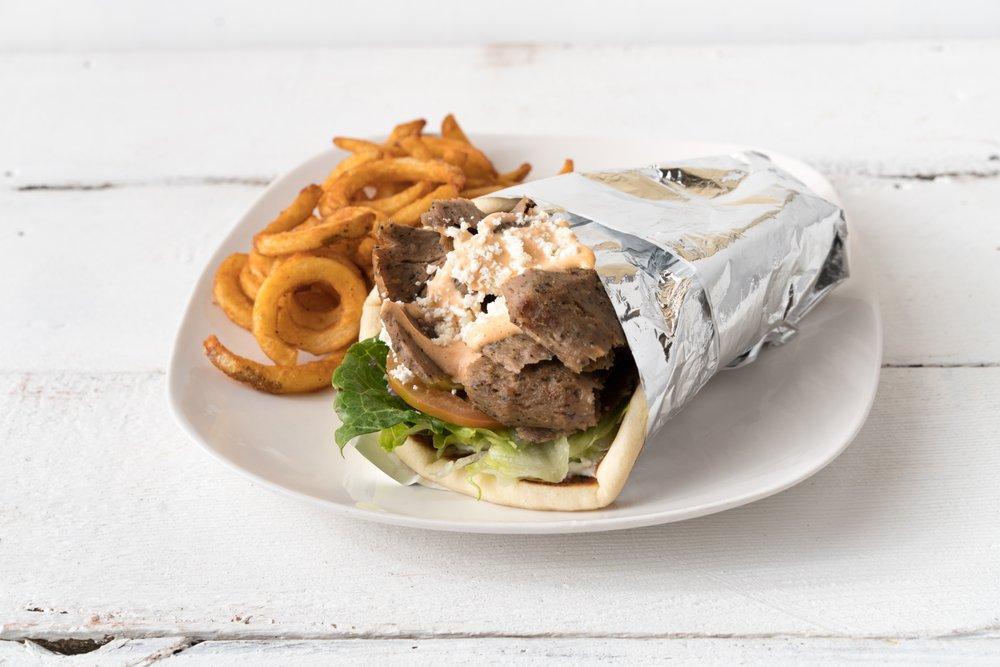 Lamb Gyro · Slices of slow roasted tender lamb gyro meat. Served in a warm pita with lettuce, tomato, onion, pickles, and tzatziki sauce. 

Add optional Spicy Garlic, Feta Cheese and Hummus with some curly fries to complete your meal.