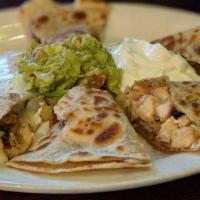 Quesadillas · Homemade flour tortilla filled with melted Oaxaca cheese and choice of meat. Served with gua...
