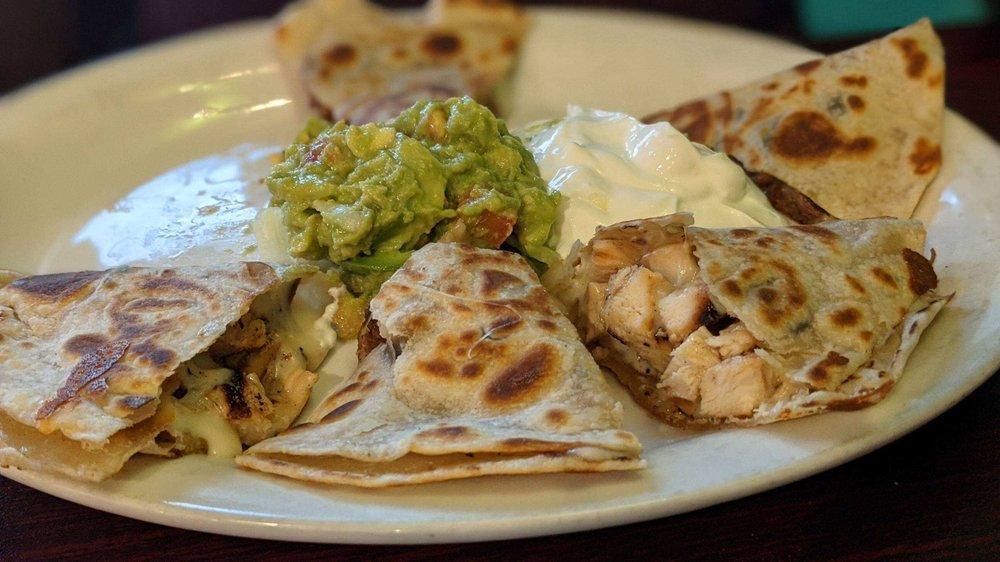 Quesadillas · Homemade flour tortilla filled with melted Oaxaca cheese and choice of meat. Served with guacamole and sour cream.