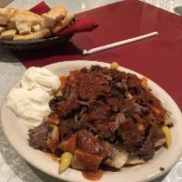 Iskender Kebab · Doner meat. Gyro meat. Doner cubes of pita bread, yogurt, tomato sauce, and butter.