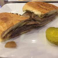 Slow Cooked Prime Rib Panini · Prime rib, grilled caramelized onions, Swiss cheese and horseradish sauce. Served with choic...
