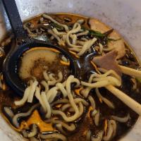 Black Tonkotsu · Flavorful pork broth with noodles topped with black garlic oil, black mushrooms green onions...