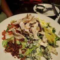 Chopped Cobb Salad · Garden greens, grilled chicken, Avocado, Crisp bacon, Diced Egg, tomatoes, Blue cheese crumb...