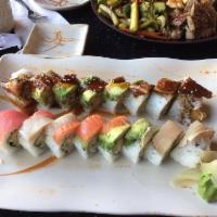 Dragon Roll · Inside: shrimp tempura, cucumber, imitation crab and avocado. Outside: BBQ eel, avocado, spe...