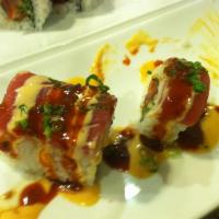 Ahi Ahi Roll · Spicy tuna, cucumber, topped with maguro, spicy sauce, spicy airline and scallions