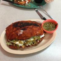 Pambazo · Mexicano bollilo bread sautéed with Guajillo salsa and stuffed with Mexican chorizo and pota...