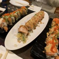 Fantasy Roll · Lobster salad, tempura, onion, top with salmon, garlic sauce, torch and onion flake.