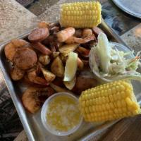 Low Country Boil · 1/2 lb. shrimp, sausage, potatoes, corn, and a side of slaw. Steamed in old bay.
