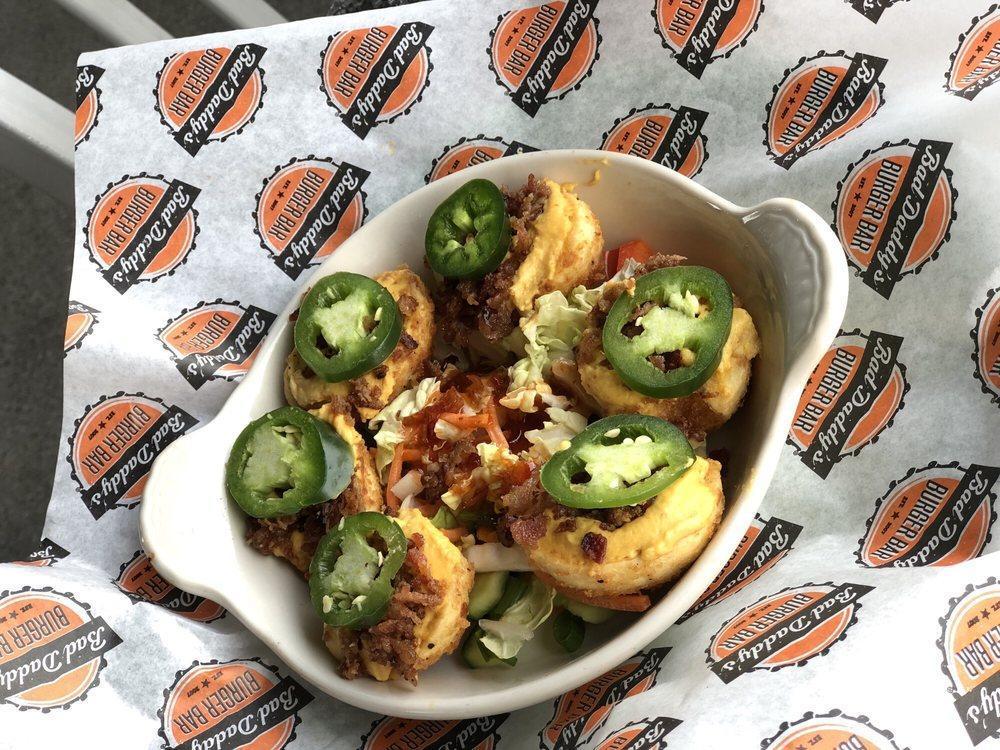 Not Your Mama's Deviled Eggs · Five lightly fried deviled eggs with a spicy filling, crumbled bacon & garnished with a fresh jalapeno slice.