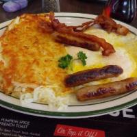 Lumberjack Breakfast · Stack of three hotcakes with three eggs, three strips of bacon, and three link sausages, plu...