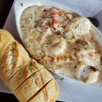 Seafood Boat · Jumbo shrimp, jumbo lump crab, scallops, and lobster smothered in a garlic cream sauce. Serv...