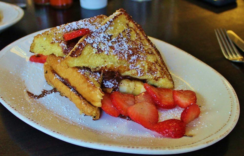 Nutella Stuffed French Toast · Thick slices of french toast sandwiched together, stuffed with Nutella and bananas then topped with fresh strawberries.