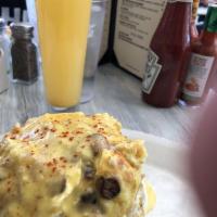 The Mile High Tower · A mixture of scrambled egg, smashed tater tots, chicken, mushroom, onion, and cream cheese s...