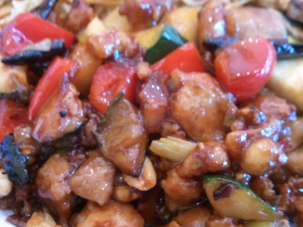 Kung Pao Chicken · A Sichuan-inspired dish with chicken, peanuts and vegetables, finished with chili peppers. Spicy.