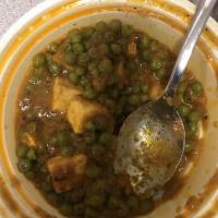 Matar Paneer · Homemade cheese and green peas in a flavorful curry sauce.