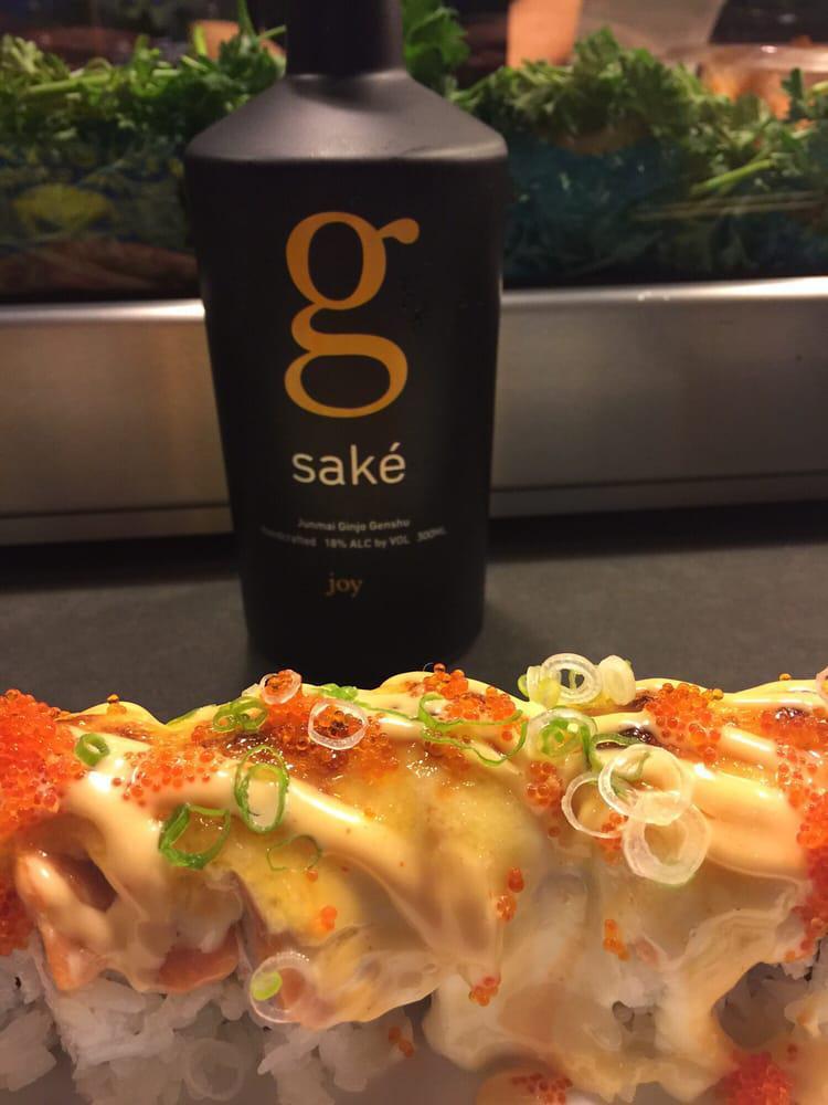 Lion King Roll · Baked. Inside: Crab mix and avocado. Outside: Salmon, tobiko, green onion. Sauce: Creamy Parmesan sauce, unagi sauce and spicy mayo.