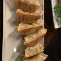 Gyoza · Pan-fried dumplings filled with ground pork and vegetables.
