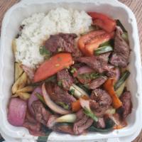 Lomo Saltado · Grill steak, white rice, french fries, tomatoes and onions.
