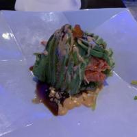 Volcano · Spicy tuna, tako, shrimp, kani, seaweed salad, avocado and ikura on top.