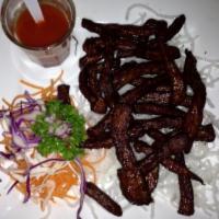Thai Beef Jerky · Deep fried marinated beef strips served with spicy Sriracha sauce. 