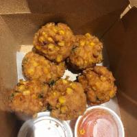 Corn Cakes · Fried seasoned fresh corn cakes served with both sweet and sour sauce and peanut sauce.