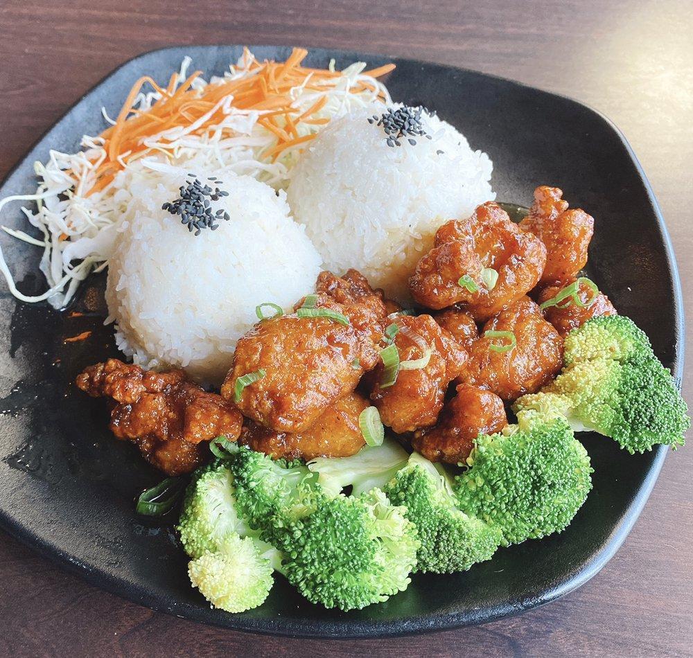 Orange Chicken · Fried marinated chicken tossed in homemade orange sauce served with steamed broccoli, green onion and jasmine rice.