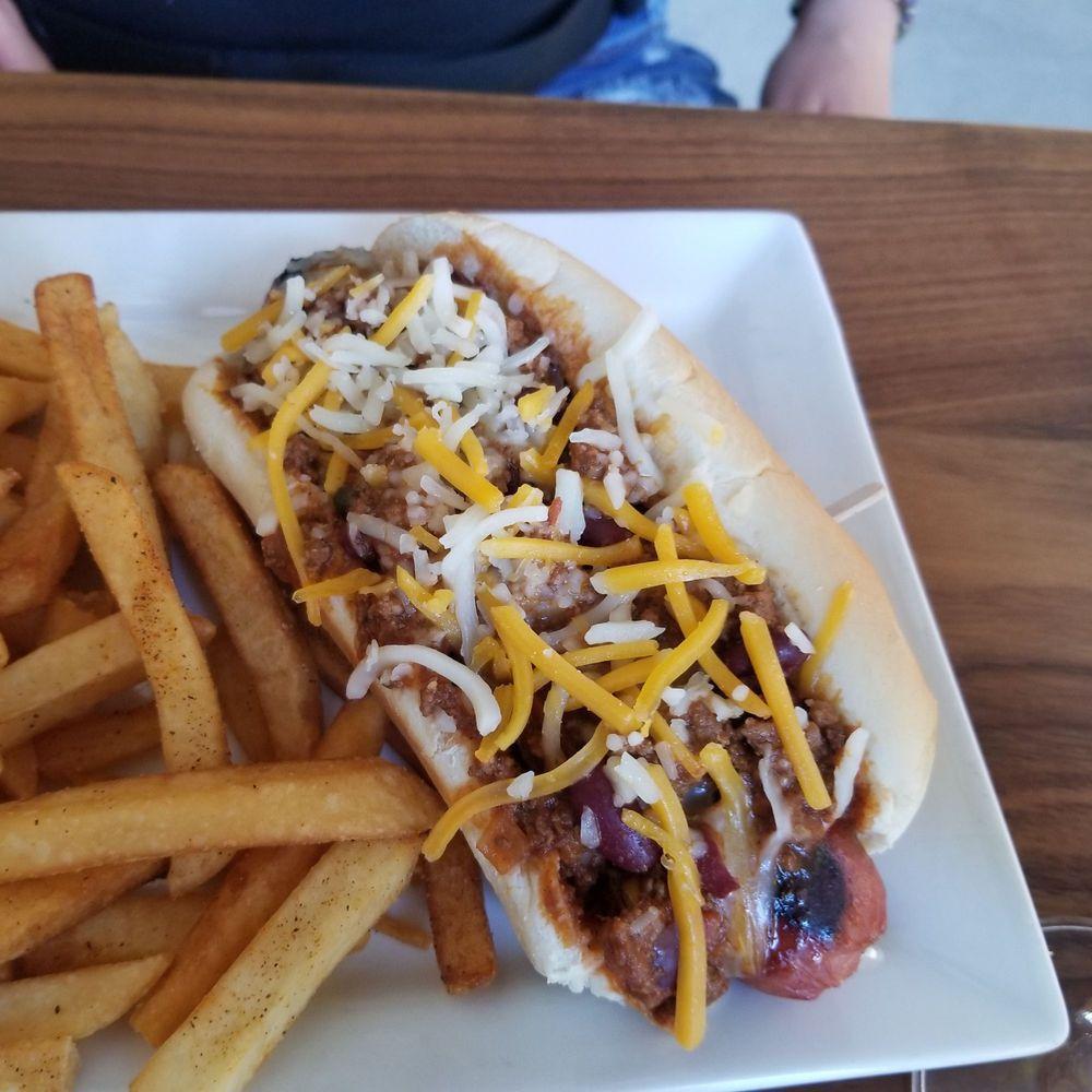 Chili Cheese Dog · 100% all-beef char-grilled and smothered with our house-made chili, shredded cheddar cheese, onion, and mustard.