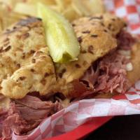 New Yorker Sandwich · Hot corned beef, cole slaw and Russian dressing on an onion roll.