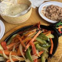 Fajita · Fire grilled steak or chicken with seasoned onions, green and red bell peppers served on a s...