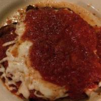 Chicken Parmigiana · Boneless and skinless chicken breast lightly breaded and flash fried. Topped with Dominick m...