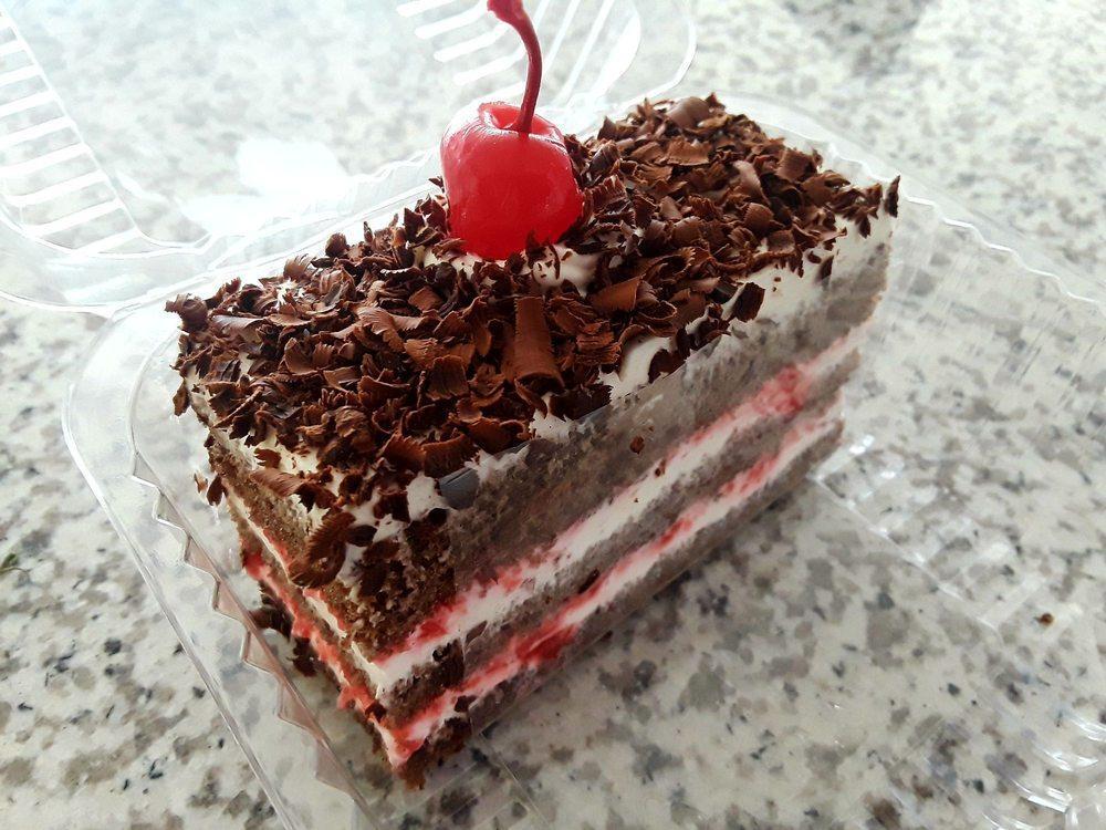 Black Forest Cake · A Biscotts favorite! A moist, chocolate cake, layered and decorated with a light whipped cream and finished with dark chocolate shavings and luscious cherries. Nine Inch Cake