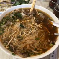 Pho Dac Biet · Special pho with combination of beef, round steak, well done flank, soft tendons, brisket, t...
