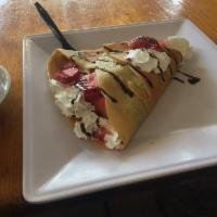 Nutella Crepe · Nutella and strawberries or bananas, whipped cream, chocolate sauce and powdered sugar.