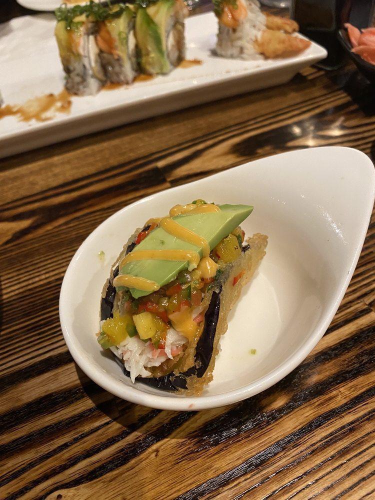 Eggplant Taco · Deep-fried eggplant in tempura batter, stuffed with spicy tuna or crab salad, shredded greens and topped with Japanese sweet mustard, unagi sauce and spicy dragon sauce.